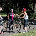 Bicycle Riders Standing and Discussing with each other.