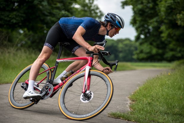 A Man Turning His Bicycle In An Empty Road